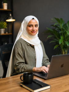 "Digital Marketing Strategist working on a laptop in a contemporary office with a textured stone wall background."